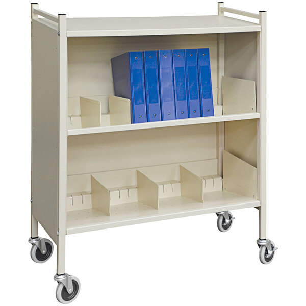 A white metal Omnimed cabinet rack with blue folders on it.