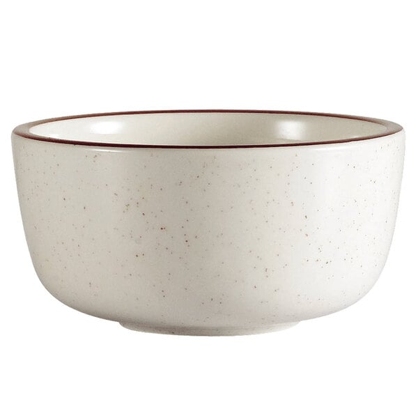 A white bowl with a brown speckle rim.