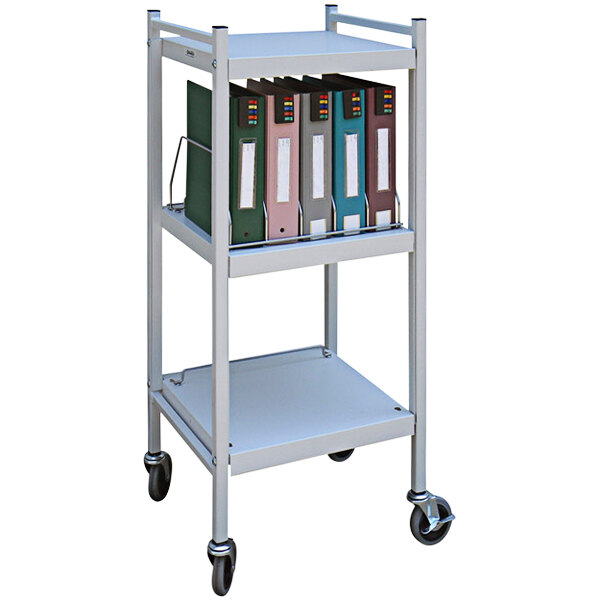 An Omnimed light gray medical cart with binders on it.