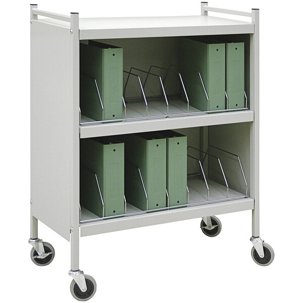 A white Omnimed medical cart with green binders on it.