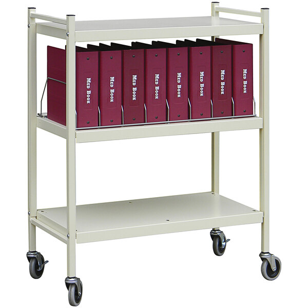 An Omnimed beige metal cart with binders on it.