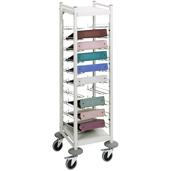 A beige Omnimed metal storage cart with shelves and binders on it.