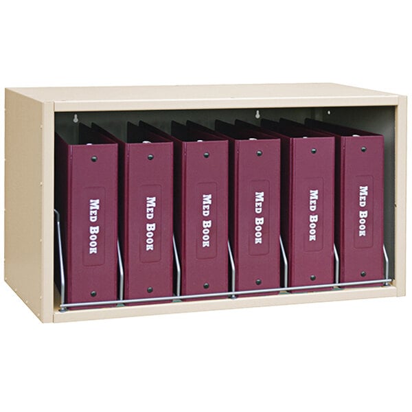 An Omnimed beige storage rack with six cubbies holding binders.