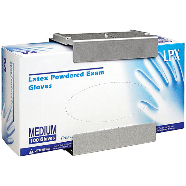 An Omnimed aluminum disposable glove dispenser holding a box of gloves on a counter.