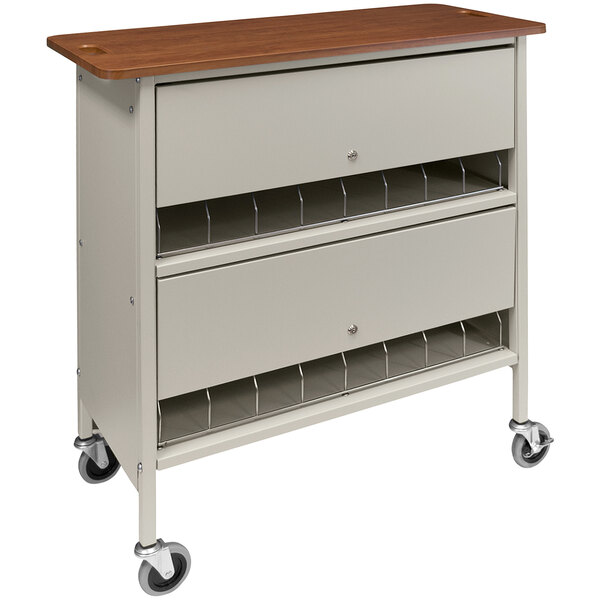 An Omnimed beige locking chart rack on wheels with a cherry wood top.