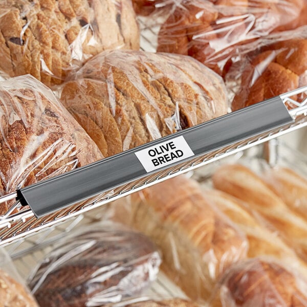 A close-up of a bag of bread with a label holder clipped on it.