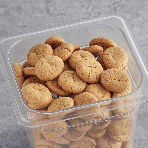 A plastic container filled with Homefree Mini Vanilla Cookies.