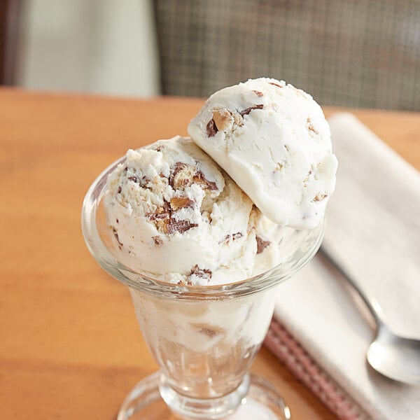 A glass bowl of TWIX® ice cream topping.