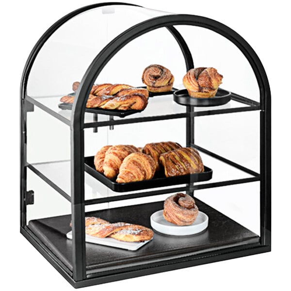 A Cal-Mil 3-tier bakery display case with pastries and breads in it.