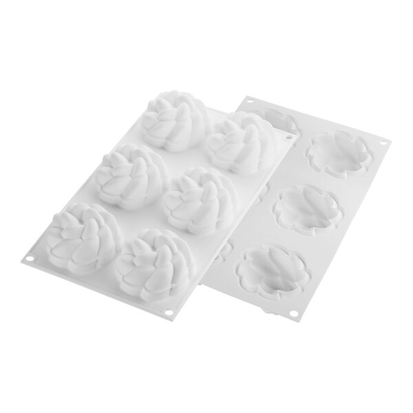 A white silicone baking mold with flower-shaped cavities.