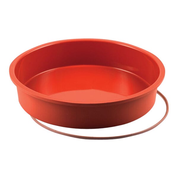 A red round silicone baking pan with a rubber ring.