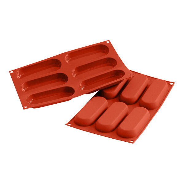 A red Silikomart silicone baking mold with six oval compartments.