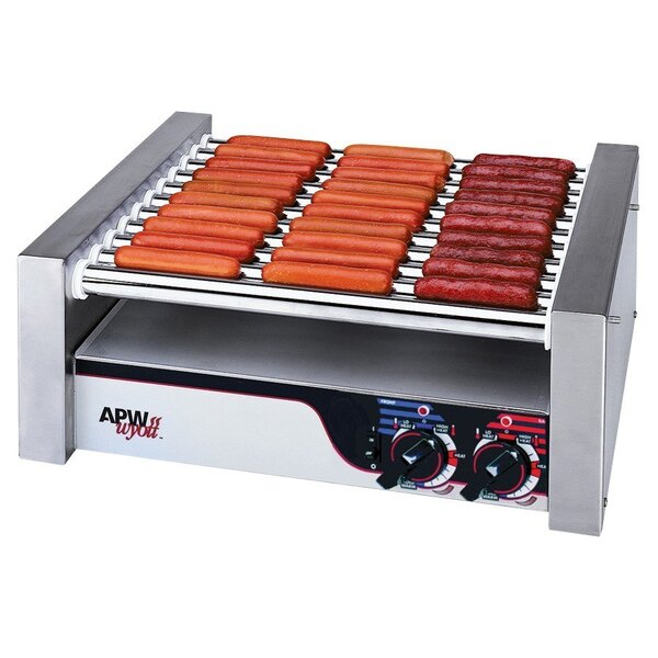 An APW Wyott slanted hot dog roller grill with hot dogs cooking.
