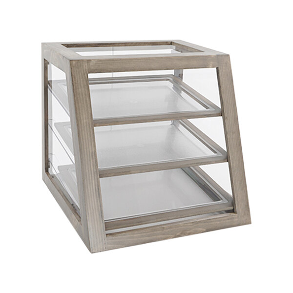 A wooden display case with glass shelves on a table in a bakery.