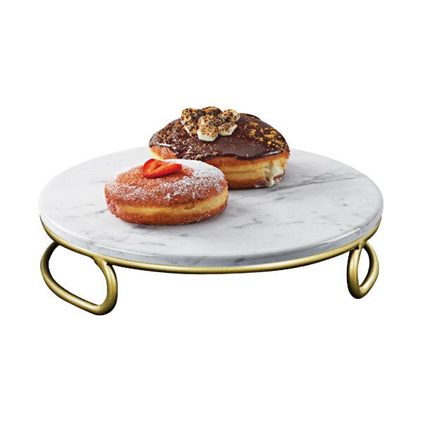 A Cal-Mil white marble display riser with donuts on it.