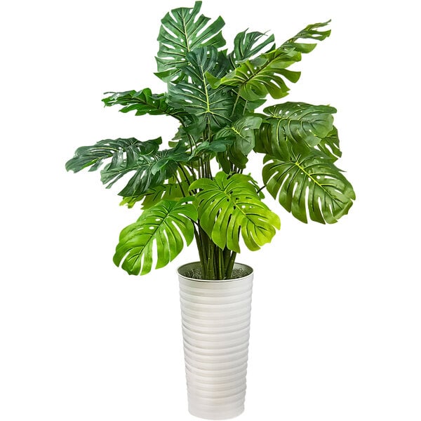 A 48" artificial monstera plant in a white metal planter.