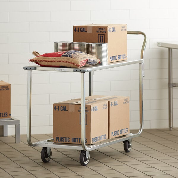 A Winholt stocking cart with boxes and cans on it.