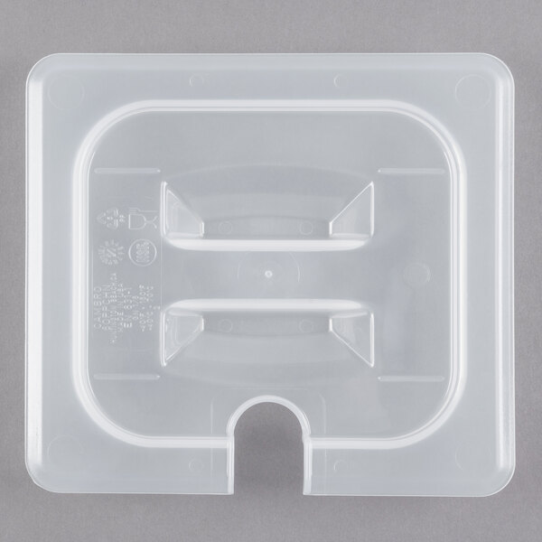 A white plastic container lid with a handle and spoon notch.