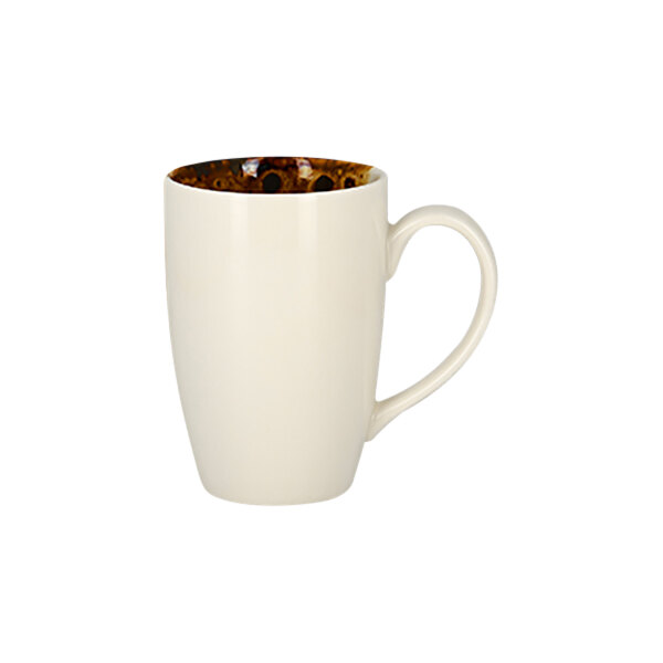 A white RAK Porcelain mug with brown spots on it.