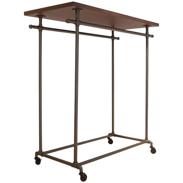An Econoco metal and wood garment rack with wheels and a woodgrain top shelf.