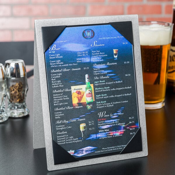 A Menu Solutions brushed aluminum table tent with a picture of beer on it.