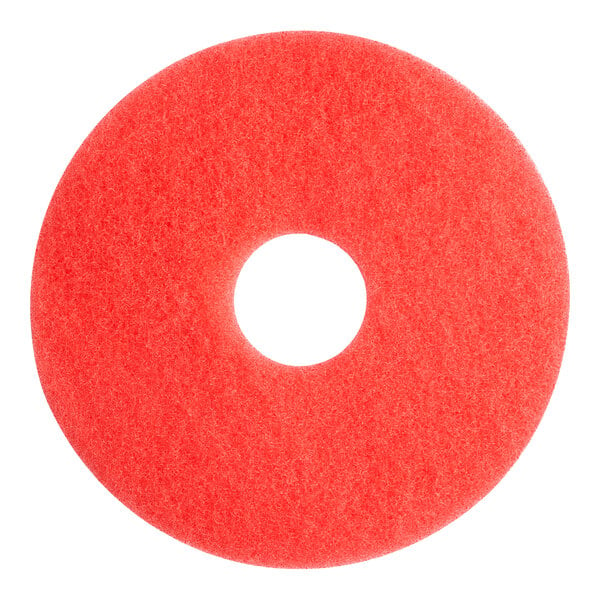 A red circular Lavex Basics floor machine pad with a hole in the middle.