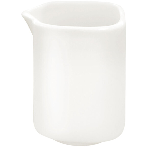 A RAK Porcelain ivory porcelain creamer with a handle and spout.