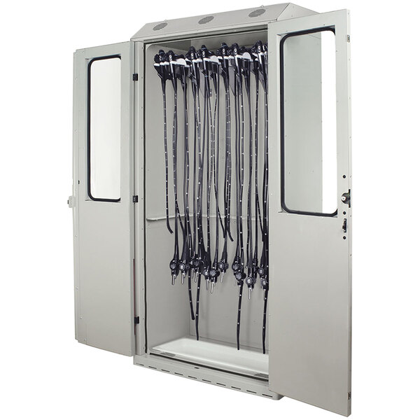 A white steel Harloff drying cabinet with black cords hanging from it.