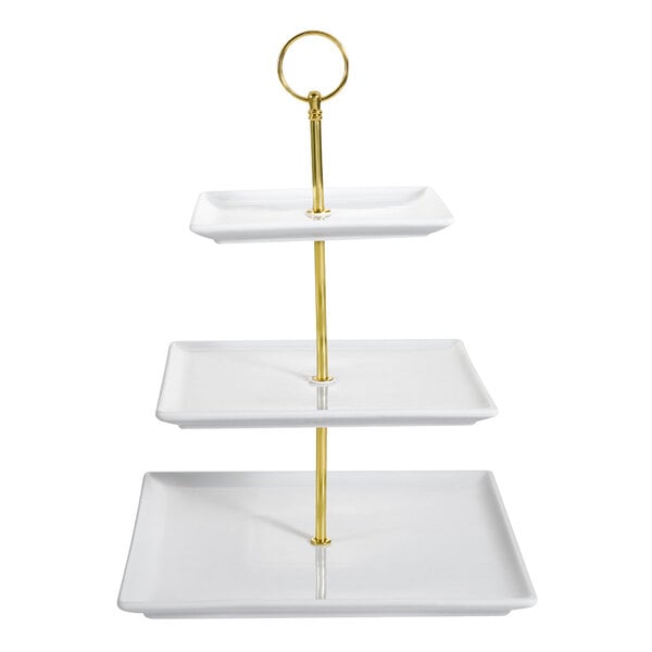 A CAC white porcelain three tiered tray stand with gold poles.