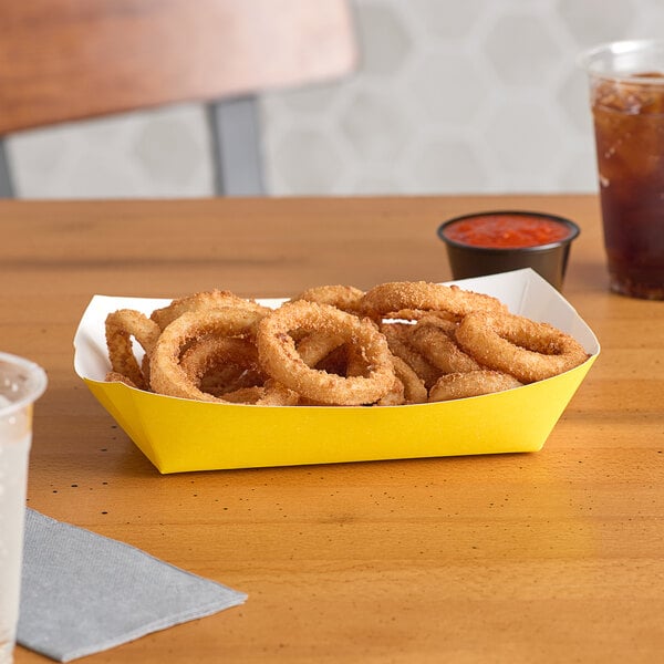 A yellow container of fried onion rings on a yellow tray.