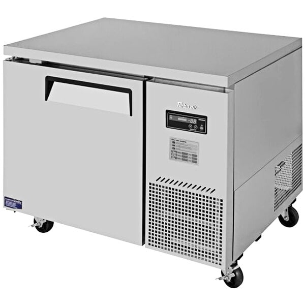 A stainless steel Turbo Air undercounter refrigerator on wheels.