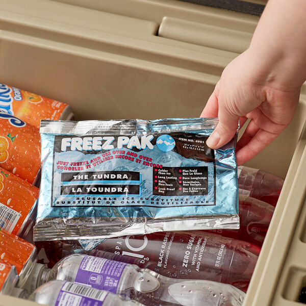 A hand holding a Lifoam Freez Pak small reusable ice pack bag.