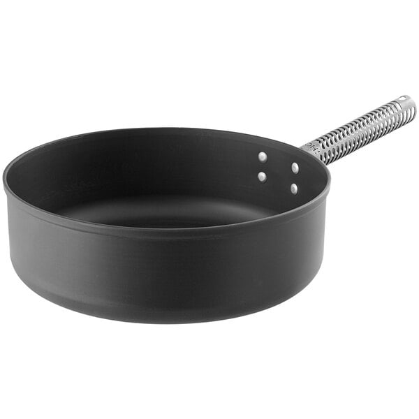 A black sauce pan with a white handle.