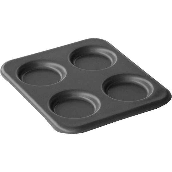 A black LloydPans baking pan with four round compartments.