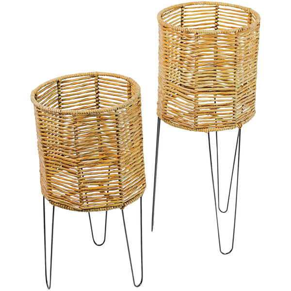 A pair of wicker baskets on metal legs.