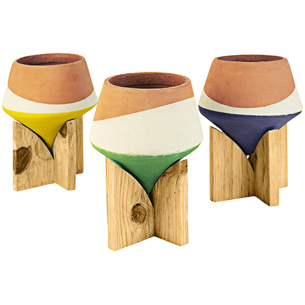 A group of Kalalou clay pots on wooden holders.