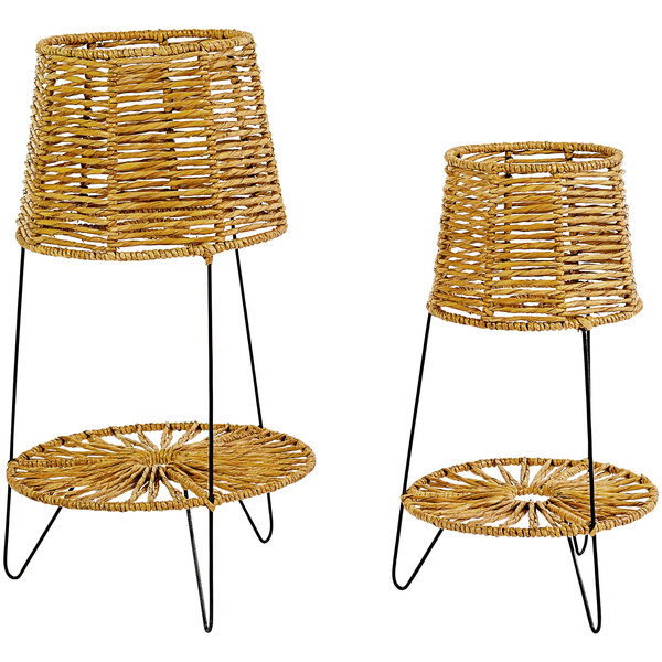 A pair of wicker baskets on iron stands.