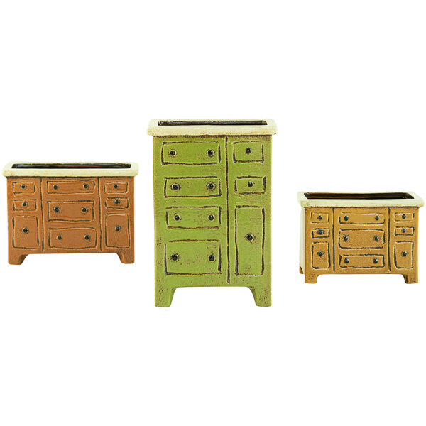 A group of Kalalou ceramic chest of drawers planters in different colors.