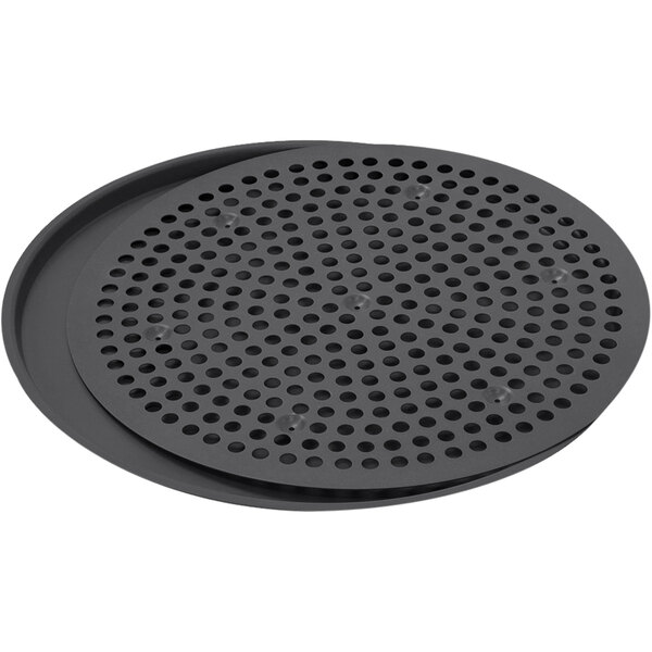A pair of round black metal trays with holes.