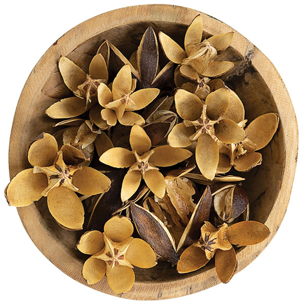 A wooden bowl filled with Kalalou dried lily flower pods.