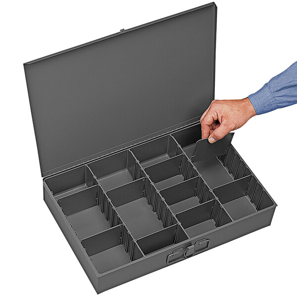 A person holding a Durham gray steel box with adjustable compartments.