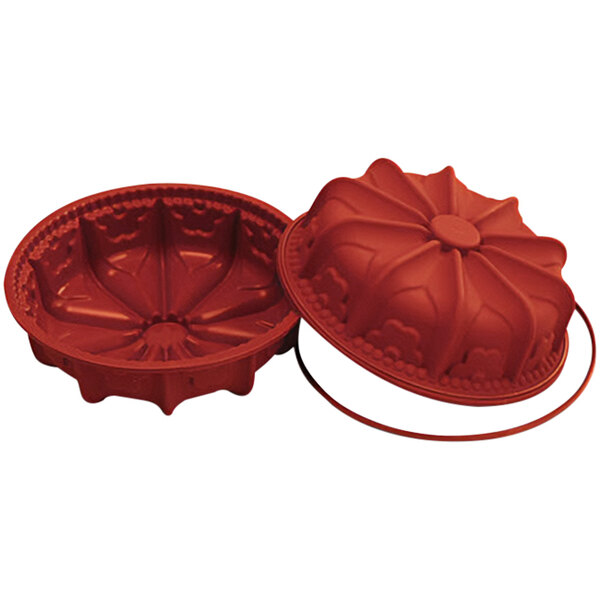 A red silicone baking mold with a fleur de lys design.