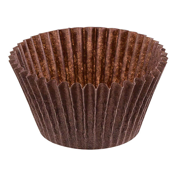 A close up of a brown paper Novacart baking cup with fluted edges.