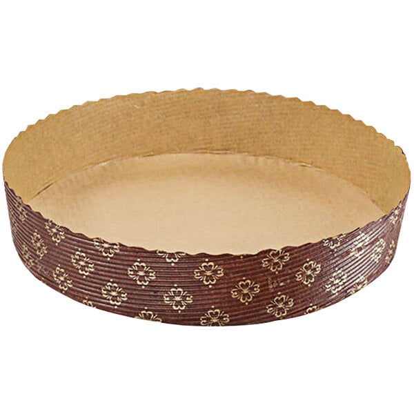 A round brown paper baking dish with a gold pattern.