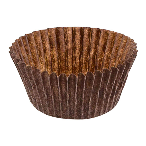 A close up of a brown Novacart fluted paper cupcake wrapper with a hole in it.
