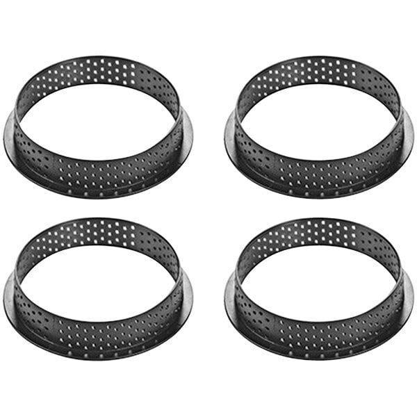 A group of black microperforated thermoplastic composite tart rings.