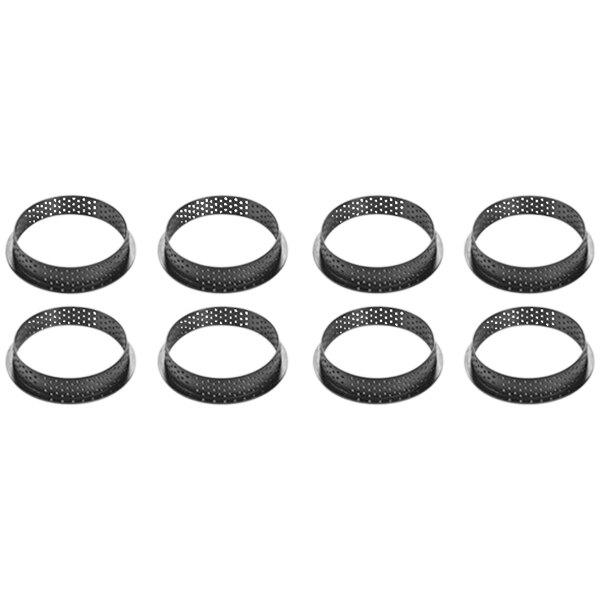 A group of black circular Silikomart tart rings with holes.