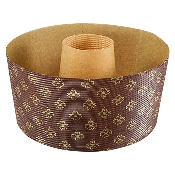 A brown and gold paper baking ring mold with a cylindrical object inside.