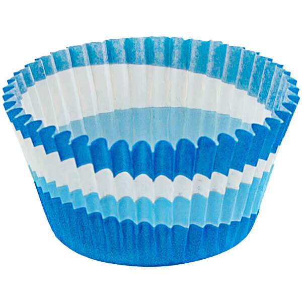 A close up of a blue and white Novacart cupcake wrapper with a fluted edge.