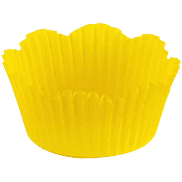 A close up of a yellow Novacart fluted baking cup with a petal design.